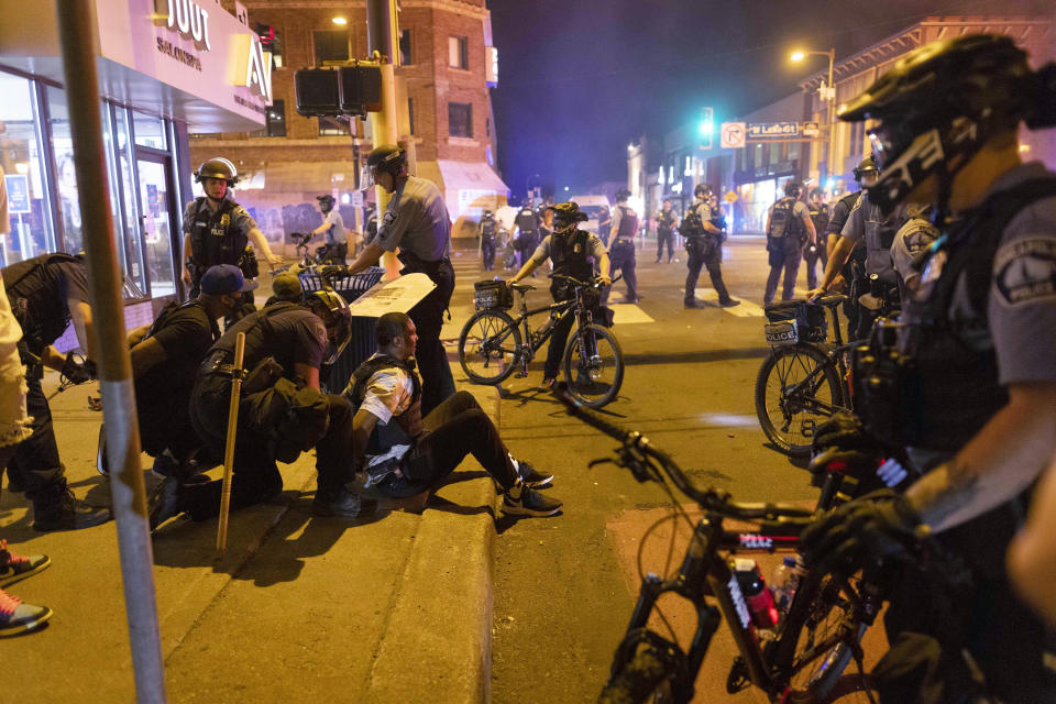 Protesters are arrested by police after a vigil was held for Winston Boogie Smith Jr. early on Saturday, June 5, 2021. Authorities said Friday that a man wanted on a weapons violation fired a gun before deputies fatally shot him in Minneapolis, a city on edge since George Floyd's death more than a year ago under an officer's knee and the more recent fatal police shooting of Daunte Wright in a nearby suburb. (AP Photo/Christian Monterrosa)