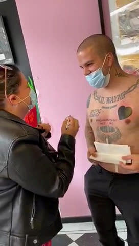 Tattoo-fan Bruno Neves, 33, proposed to his girlfriend with an inking which read "Will you marry me?", complete with 'Yes/No' tick boxes. Romantic Bruno popped the question to girlfriend Patricia Calado, 34, last week, with the help of his favourite tattoo artist Arron Adams, 33. The romantic delivery driver, from Great Yarmouth, Norfolk, asked his fiancée-to-be to come with him to A Sailor's Grave Tattoo Studio in the seaside town. Bruno, whose body already featured 20 inkings, told her he was getting some cover-up ink on an existing tat. But as mum-of-two Patricia sat in the waiting room for around 45 minutes, she had no idea that Bruno was actually getting the words "Will you marry me?" tattooed across his chest. A nervous Bruno, who is also a dad to a four-year-old son, even completed the tattoo with 'Yes' or 'No' tickboxes beneath the big question. And when a stunned Patricia read the words on his chest, she quickly grabbed a pen and put a cross through the 'Yes' box - which was then also tattooed on Bruno's chest.