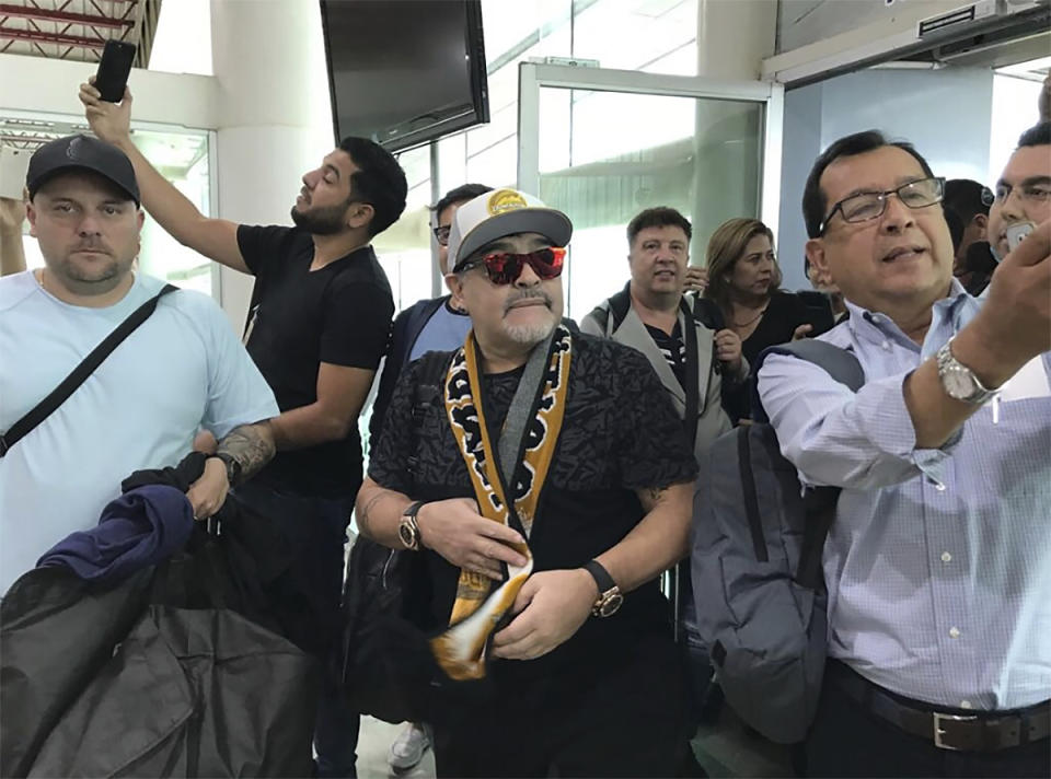 In this handout photo provided by Prensa Club Dorados de Sinaloa, Argentine soccer legend Diego Maradona walks through the airport in Culiacan, Mexico, Saturday, Sept. 8, 2018. Maradona arrived in northern Mexico Saturday afternoon, to begin his new job as head coach of the second-tier Mexican soccer club Dorados of Sinaloa. (Prensa Club Dorados de Sinaloa via AP)