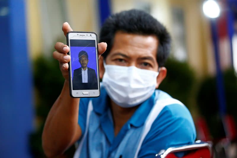 Sugiarto shows a photo of his nephew Rion Yogatama, a victim of Sriwijaya Air Flight SJ 182 that crashed into the sea off the Jakarta coast, in Indonesia