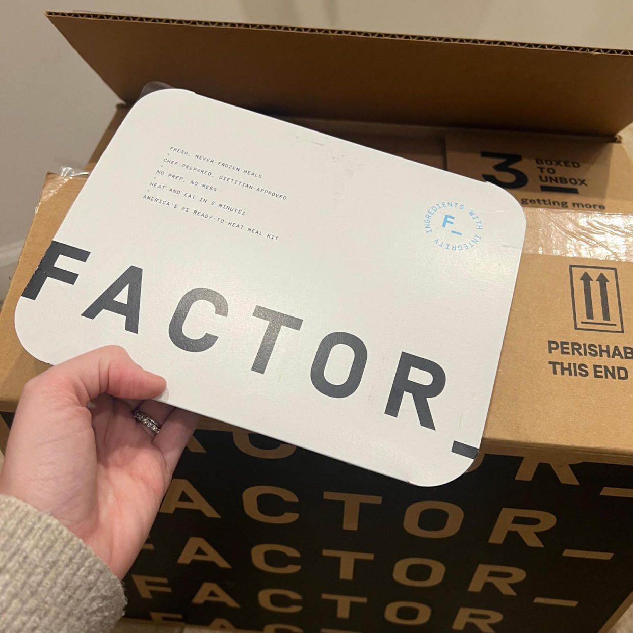 Factor prepared meal with a shipping box. (Courtesy of Mili Godio; Factor)