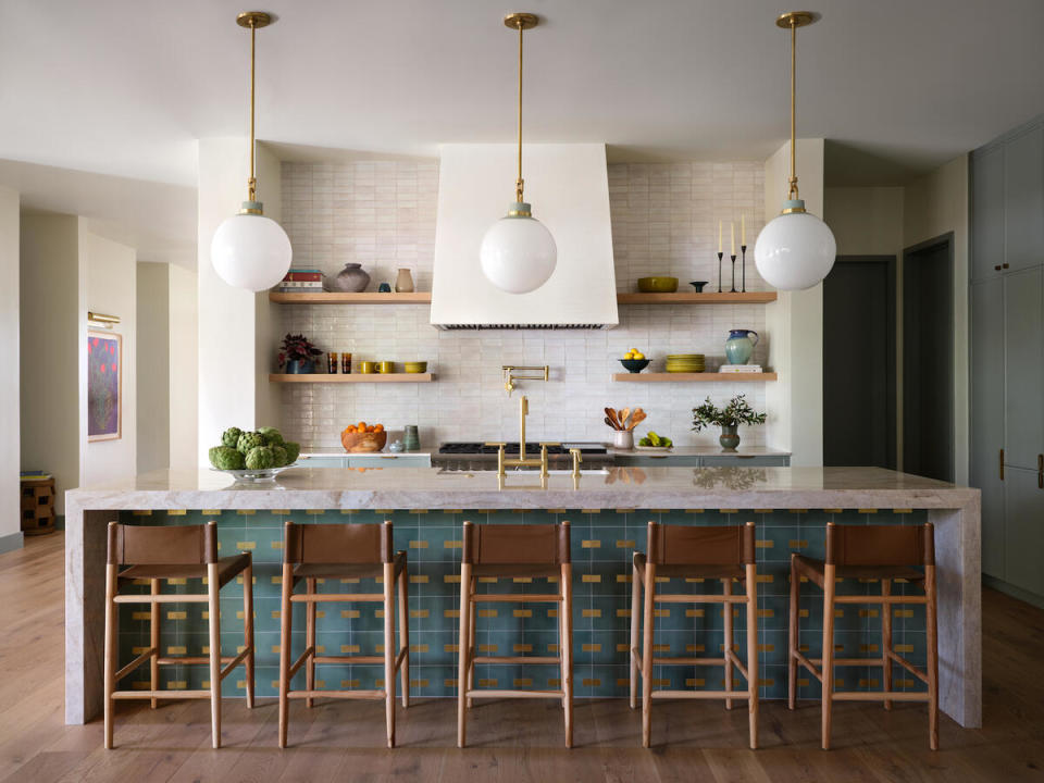 Statement tile on an island brings a sophisticated pop of personality to this kitchen by Annie Downing, who aims to have 95 percent of a project’s furniture in before scheduling an installation 