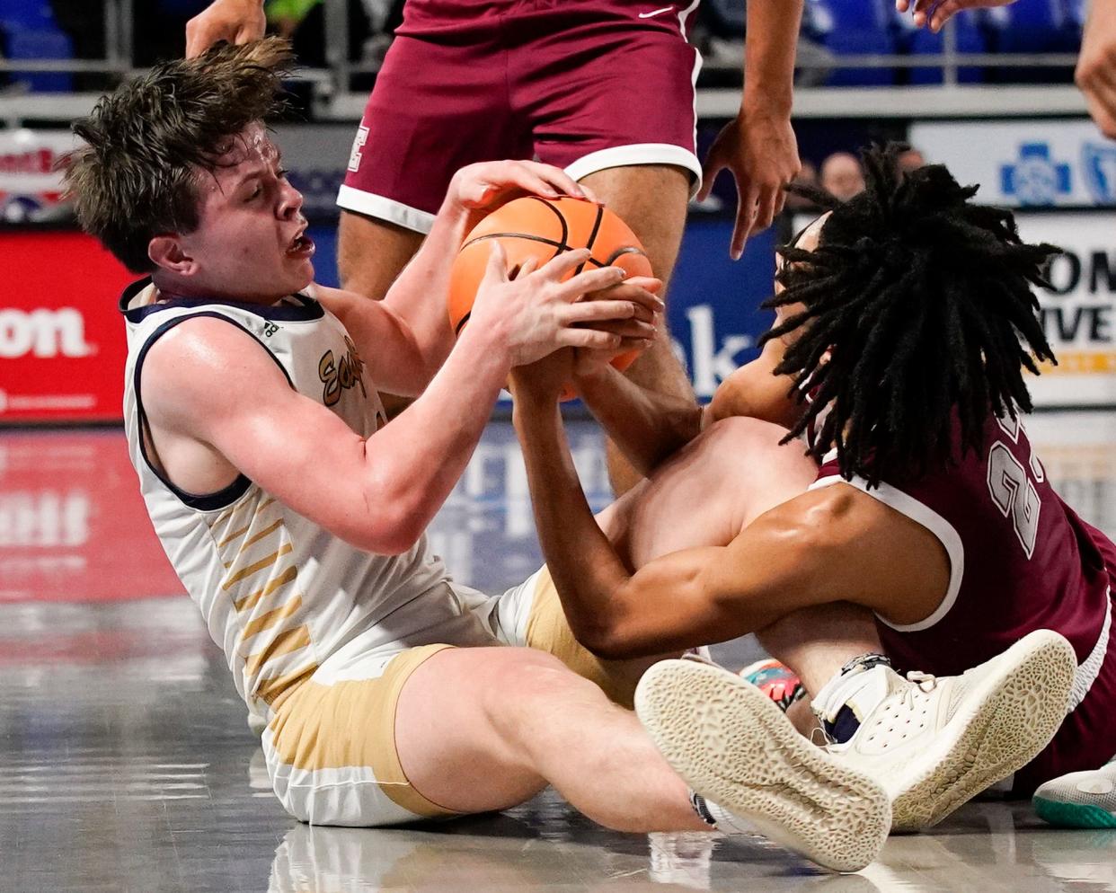 Independence guard Jett Montgomery (1) and Memphis East forward Joshua Thompson (23) battle for a loose ball during the first half of a TSSAA Class 4A State Boys' Basketball Tournament semifinal game at Murphy Center Friday, March 17, 2023 in Murfreesboro, Tenn. 