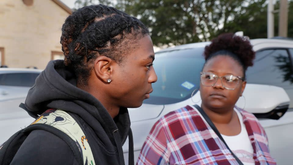 Darryl George, left, a 17-year-old junior, and his mother Darresha George, right, speak to reporters before school starts at Barbers Hill High School.  - Michael Wyke/AP