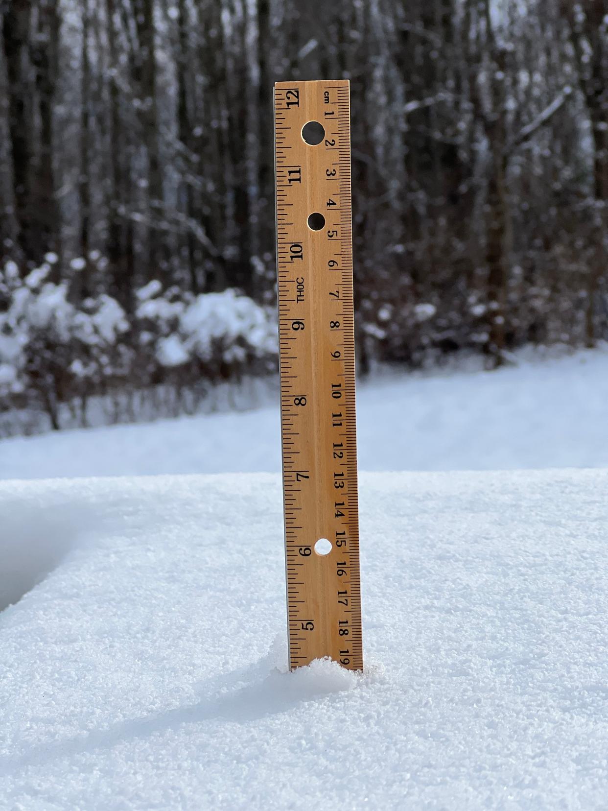 A ruler shows snow at about 4-and-a-half inches deep on Dec. 12, 2023 in Williston following a snowstorm that ended the previous evening.