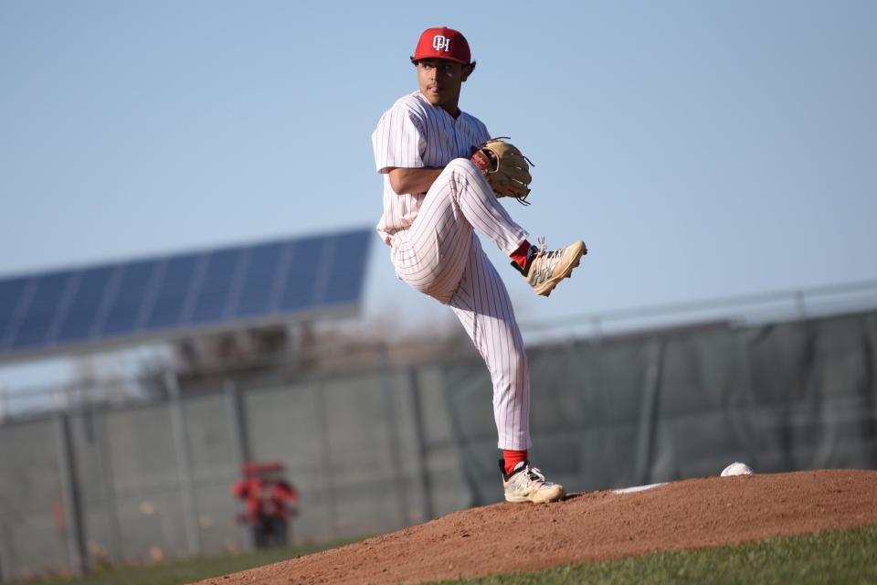 Oak Hills' Paul Montoya winds up to deliver a pitch during the first inning against Apple Valley on Friday, March 8, 2024. Oak Hills defeated Apple Valley 5-3 in the Mojave River League opener.