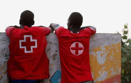 Red Cross volunteers watch as soldiers from the Economic Community Of West African States (ECOWAS) patrol at Senegal's border with Gambia in Karang January 20, 2017. REUTERS/Thierry Gouegnon