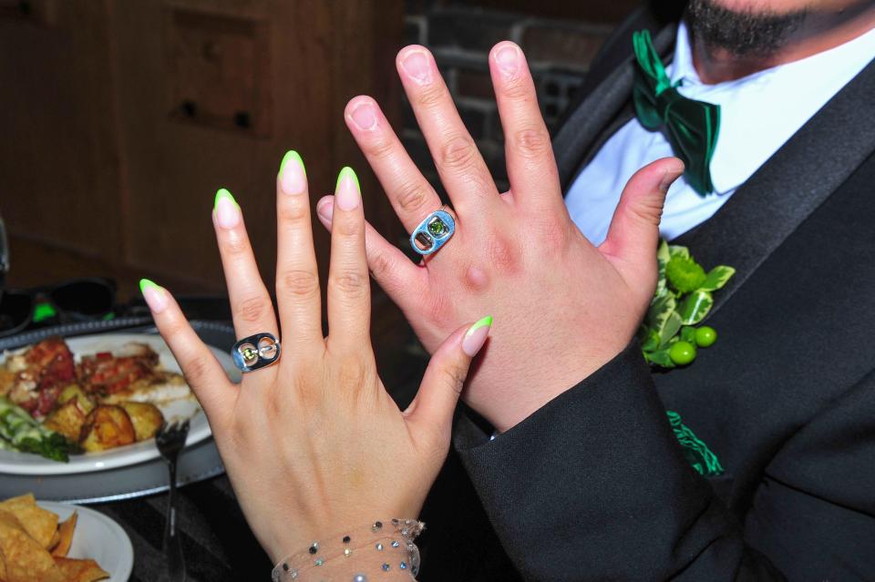 Alina Ibarra and Nicolas Enriquez show off their pop-top wedding rings.