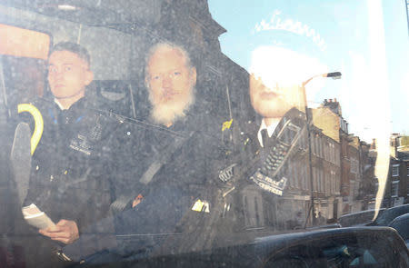 FILE PHOTO: WikiLeaks founder Julian Assange leaves the Westminster Magistrates Court in the police van, after he was arrested in London, Britain April 11, 2019. REUTERS/Henry Nicholls/File Photo