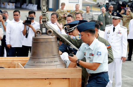 Philippine Air Force personnel unload the bells of Balangiga after their arrival at Villamor Air Base in Pasay, Metro Manila, Philippines December 11, 2018. REUTERS/Erik De Castro