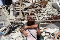 <p>Two residents hug each other next to collapsed and damaged houses in Pescara del Tronto, central Italy on Aug. 24, 2016, following a 6.2 magnitude earthquake, according to the United States Geological Survey (USGS), that struck at around 3:30 am local time (1:30 am GMT). The quake was felt across a broad section of central Italy, in Umbria, Lazio and Marche Regions, including the capital Rome where people in homes in the historic center felt a long swaying followed by aftershocks. (EPA/CROCCHIONI) </p>
