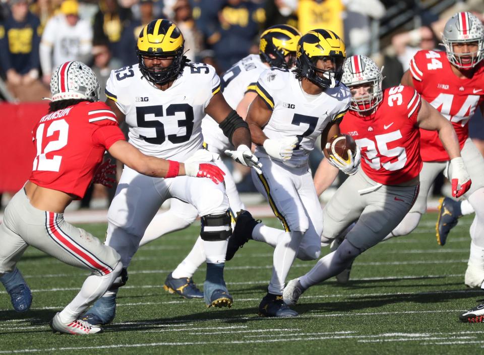 Michigan Wolverines running back Donovan Edwards (7) runs as lineman Trente Jones (53) blocks vs. the Ohio State Buckeyes during the second half at Ohio Stadium in Columbus, Saturday, Nov. 26, 2022.