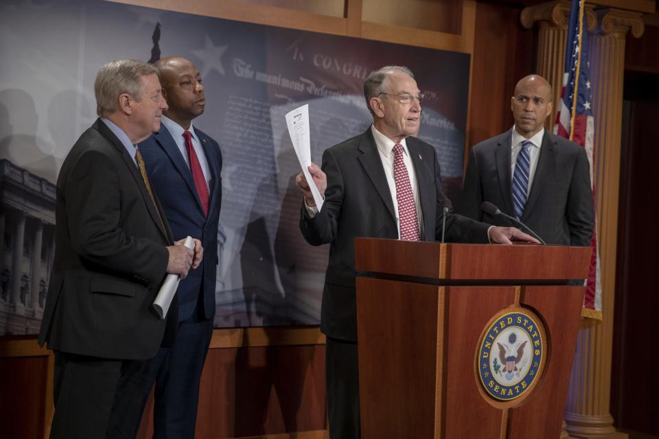 Sens. Dick Durbin, D-Ill.,  Tim Scott, R-S.C.,  and Cory Booker, D-N.J.,  listen to Senate Judiciary Committee Chairman Chuck Grassley, R-Iowa,  talk about passage of the First Step Act at a press conference  Dec. 19, 2018 in Washington, D.C.