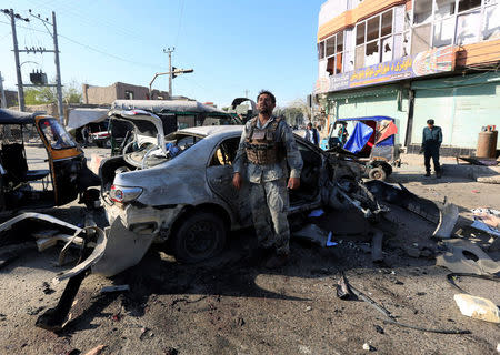 An Afghan security forces member inspects at the site of a suicide attack in Jalalabad, Afghanistan March 7, 2018. REUTERS/Parwiz