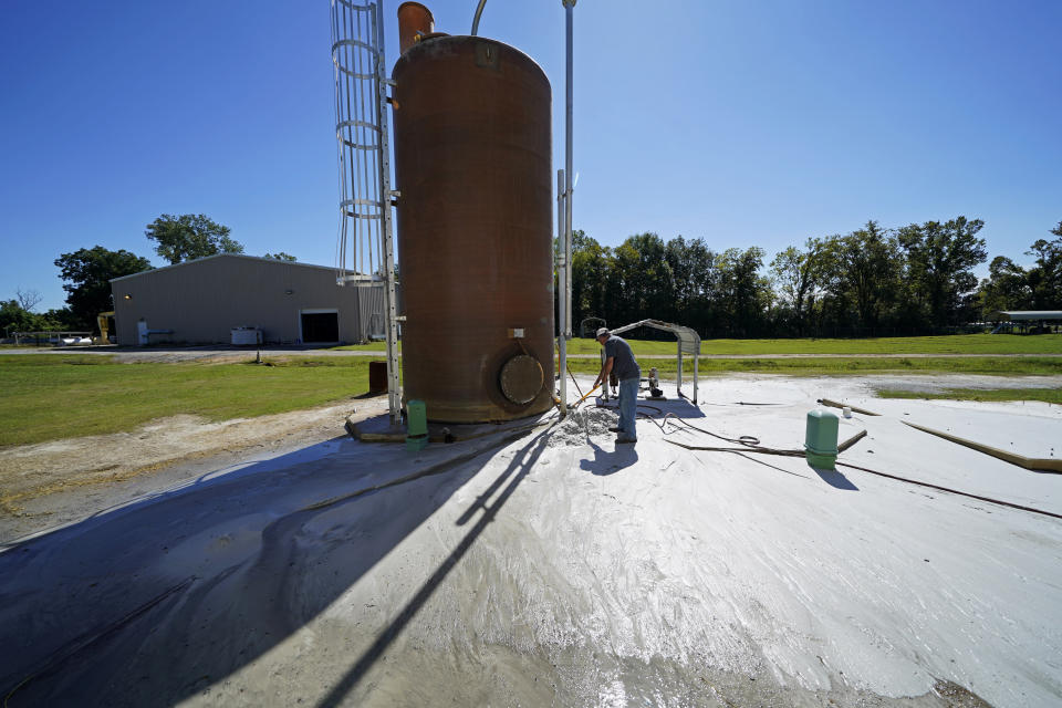 Plant operator Mike Gandy flushes sand out of a filter as part of the newer water plant equipment in Ferriday, La., Tuesday, Sept. 13, 2022. The water is now tested regularly and plant operators are working on new treatment methods. (AP Photo/Gerald Herbert)