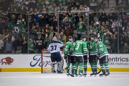 Jan 19, 2019; Dallas, TX, USA; Dallas Stars defenseman Miro Heiskanen (4) and defenseman John Klingberg (3) and left wing Jamie Benn (14) and center Tyler Seguin (91) celebrate the power play goal by Seguin against Winnipeg Jets goaltender Connor Hellebuyck (37) during the third period at the American Airlines Center. Mandatory Credit: Jerome Miron-USA TODAY Sports