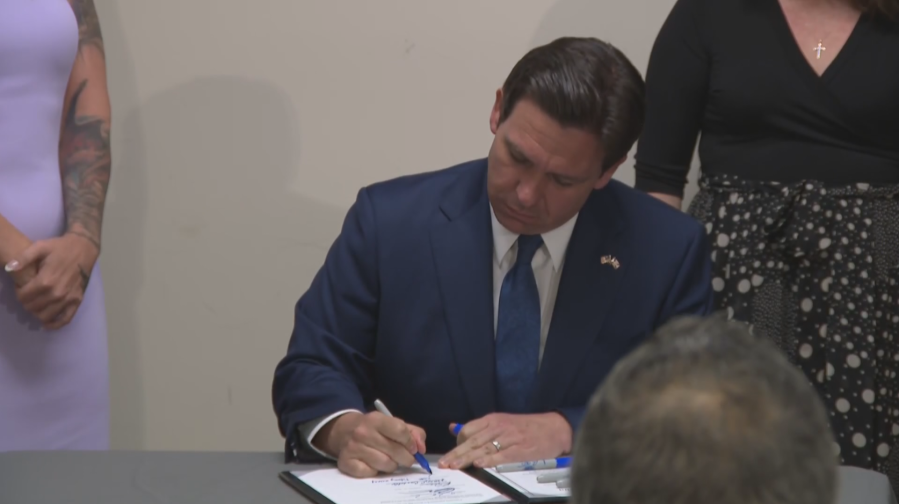 <em> Gov. Ron DeSantis signs HB-117</em>