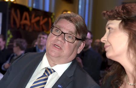 The Finns Chairman Timo Soini (L) and party secretary Riikka Slunga-Poutsalo look on after the result announcing of the pre-elections votes at the party's parliamentary elections reception in Helsinki April 19, 2015. REUTERS/Martti Kainulainen/Lehtikuva