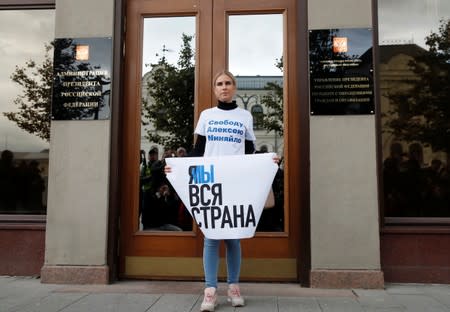 Russian opposition figure Lyubov Sobol holds a placard during a rally in support of Pavel Ustinov, in Moscow