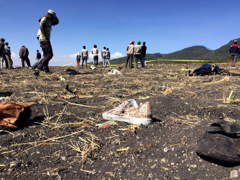 FILE PHOTO: People walk at the scene of the Flight ET 302 plane crash, near the town of Bishoftu