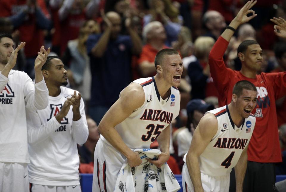 The Arizona bench cheers during the first half in a regional final NCAA college basketball tournament gameagainst Wisconsin, Saturday, March 29, 2014, in Anaheim, Calif. (AP Photo/Jae C. Hong)