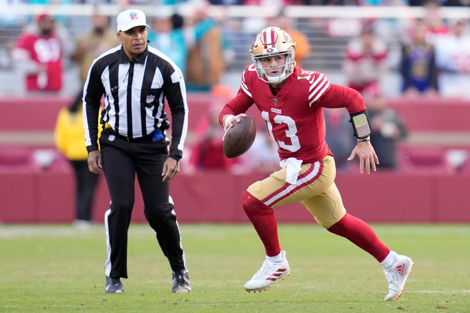 San Francisco 49ers quarterback Brock Purdy (13) rolls out against the Miami Dolphins during the second half of an NFL football game in Santa Clara, Calif., Sunday, Dec. 4, 2022. (AP Photo/Godofredo A. VÃ¡squez)