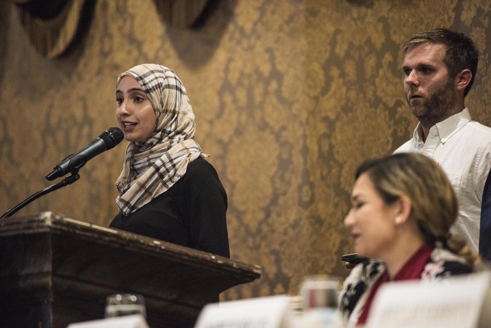 Rowaida Abdelaziz speaks to the audience, as Chris Mathias listens.