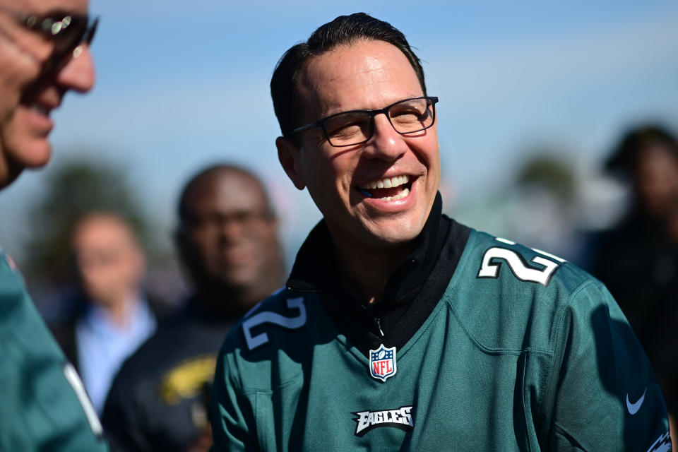 Democratic nominee for governor Josh Shapiro smiles while wearing a Philadelphia Eagles jersey.