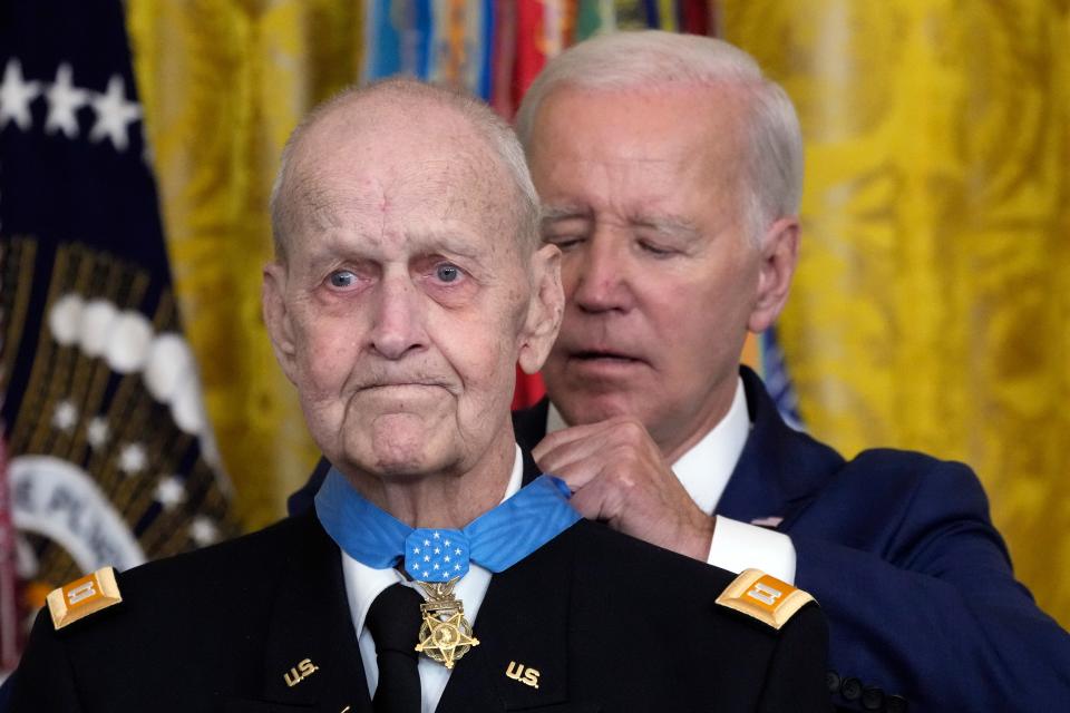 President Joe Biden awards the Medal of Honor to Capt. Larry Taylor, an Army pilot from the Vietnam War who risked his life to rescue a reconnaissance team that was about to be overrun by the enemy, during a ceremony in the East Room of the White House.