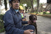 <p>Rescuer Ricardo Canseco Rodriguez and his dog Rocco rest during a break in search and rescue operations in San Gregorio Atlapulco, Mexico, Friday, Sept. 22, 2017. Mexican officials are promising to keep up the search for survivors as rescue operations stretch into a fourth day following Tuesday’s major earthquake that devastated Mexico City and nearby states. (AP Photo/Moises Castillo) </p>