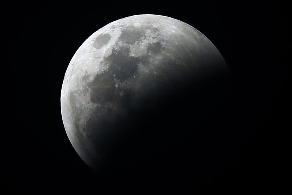 The moon is seen partially covered during a lunar eclipse seen in the sky over Ciudad Hidalgo, Chiapas state, Mexico, Sunday, Jan. 20, 2019. The entire eclipse will exceed three hours. Totality - when the moon's completely bathed in Earth's shadow - will last an hour. Expect the eclipsed, or blood moon, to turn red from sunlight scattering off Earth's atmosphere. (AP Photo Marco Ugarte)