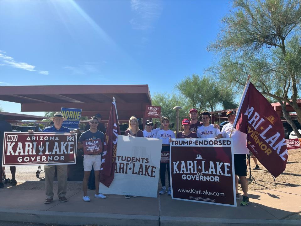 Kari Lake campaign volunteers get ready for her 9 a.m. appearance outside of the Paradise Valley Town Hall polling place.