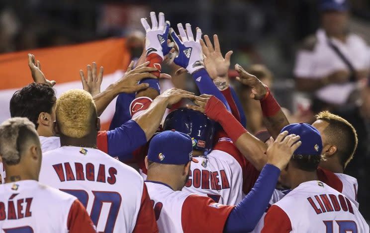 Puerto Rico celebrates an unexpectedly dominant win against Venezuela. (AP) 
