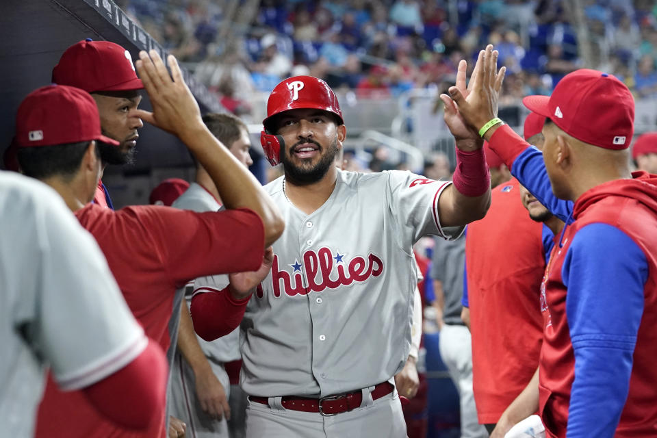 Philadelphia Phillies' Darick Hall is congratulated after scoring on a double by J.T. Realmuto during the seventh inning of the team's baseball game against the Miami Marlins, Friday, July 15, 2022, in Miami. The Phillies won 2-1. (AP Photo/Lynne Sladky)