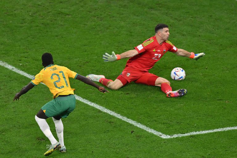 Argentina's goalkeeper #23 Emiliano Martinez saves a shot by Australia's forward #21 Garang Kuol during the Qatar 2022 World Cup round of 16 football match between Argentina and Australia at the Ahmad Bin Ali Stadium in Al-Rayyan, west of Doha on December 3, 2022. (Photo by Glyn KIRK / AFP)