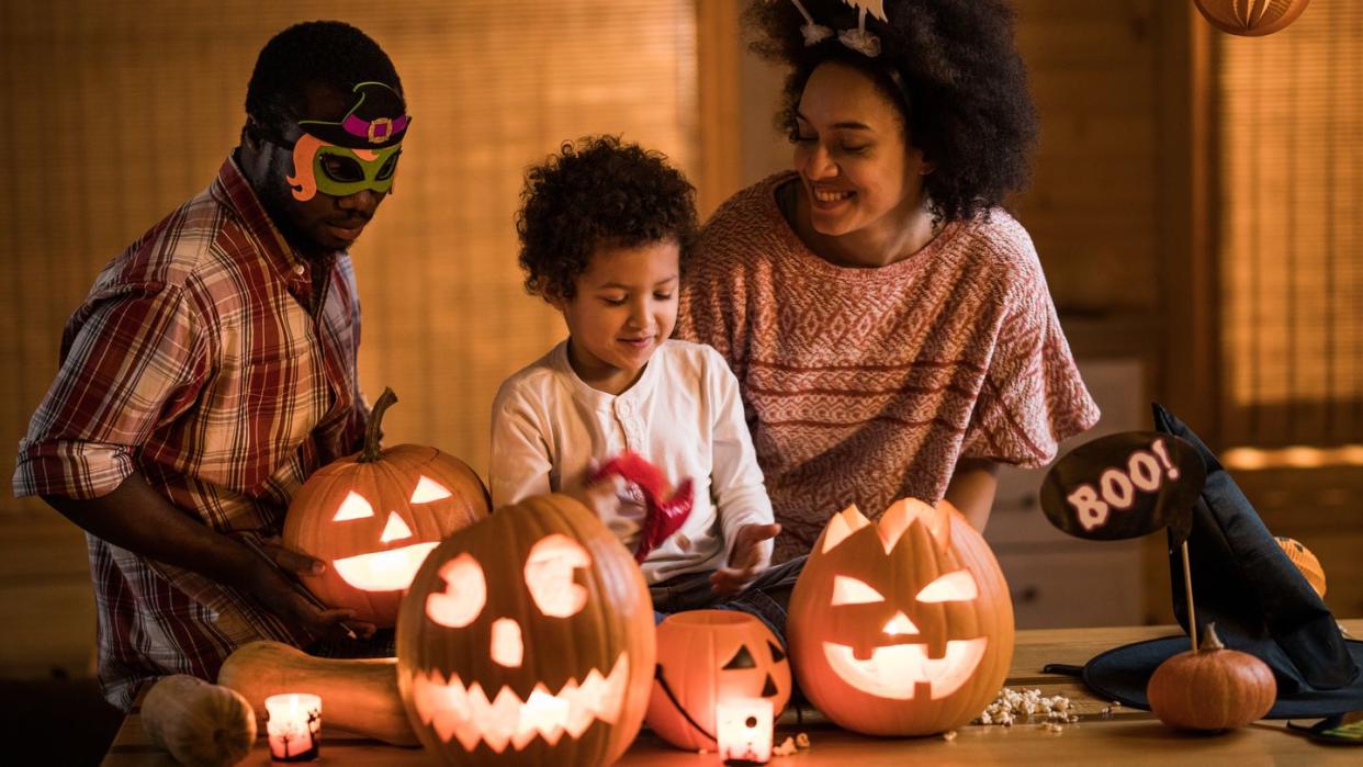 family carving halloween pumpkins