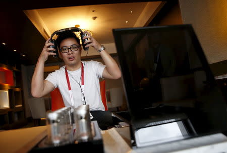 An invited guest enjoys a private listening experience of a test unit of the Sennheiser HE 1 sound system, which is expected to retail for about S$77370 ($55000), in a hotel suite during the CanJam headphone and personal audio expo in Singapore February 21, 2016. REUTERS/Edgar Su