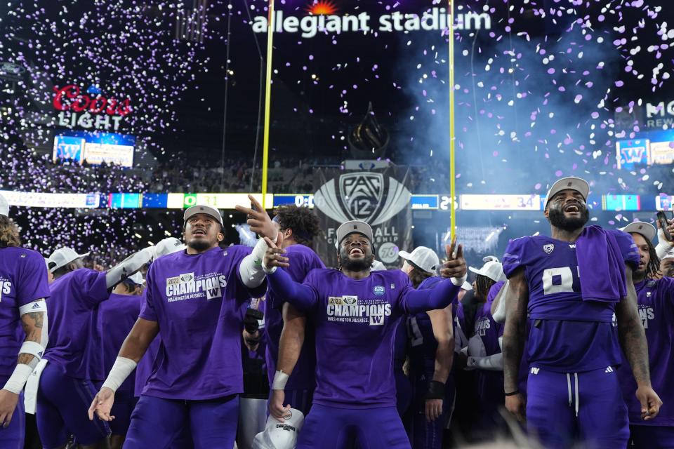 The Washington Huskies players celebrate their victory over the Oregon Ducks in the Pac-12 Championship game at Allegiant Stadium on Dec. 1.