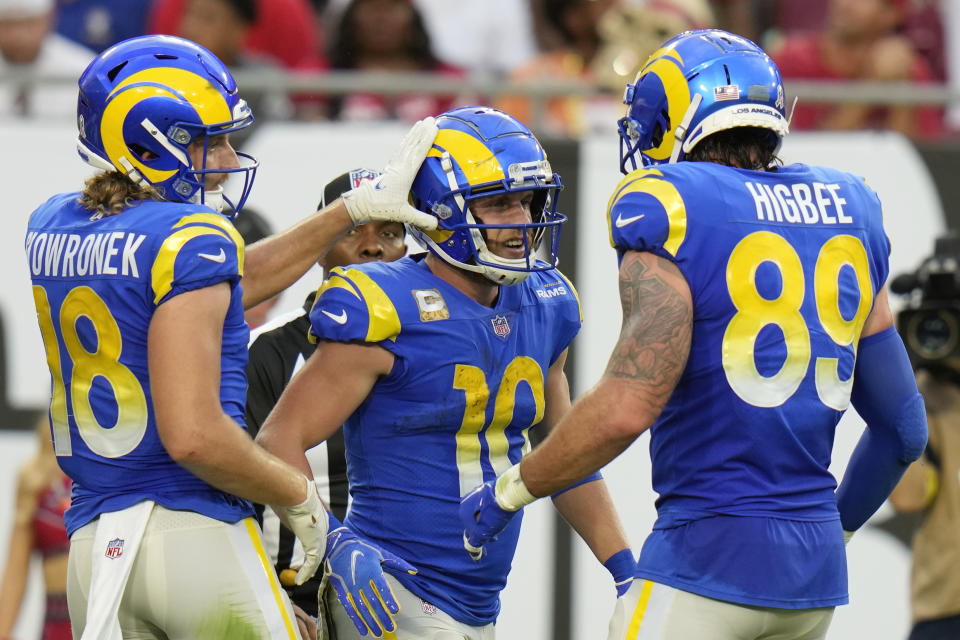 Los Angeles Rams wide receiver Cooper Kupp (10) is congratulated by teammates after scoring a 69-yard touchdown reception during the first half of an NFL football game between the Los Angeles Rams and Tampa Bay Buccaneers, Sunday, Nov. 6, 2022, in Tampa, Fla. (AP Photo/Chris O'Meara)