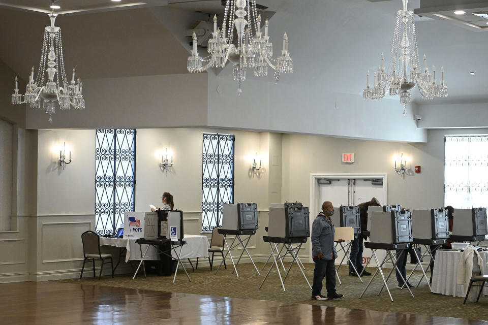 People vote at the Crystal Ballroom in New Britain, Conn., Tuesday, Nov. 8, 2022. (AP Photo/Jessica Hill)