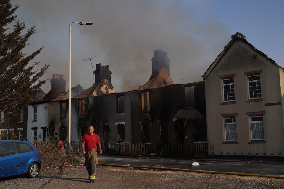 Row of houses destroyed in the Wennington fire (PA)