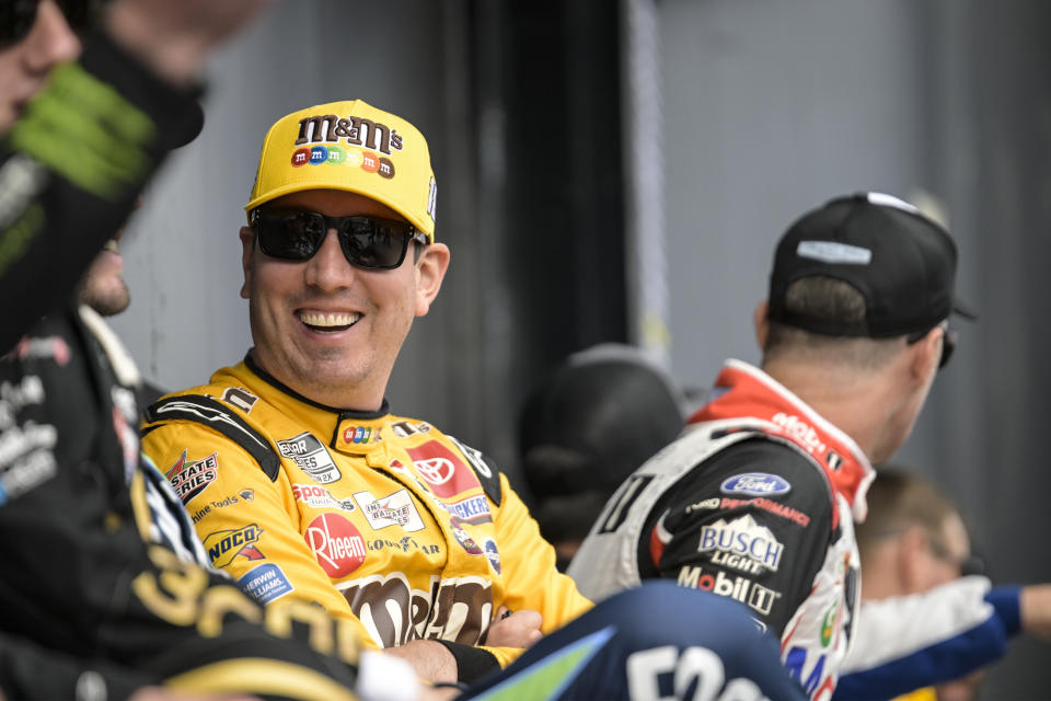 FILE - Kyle Busch smiles prior to a NASCAR Cup Series auto race at Charlotte Motor Speedway, Sunday, Oct. 9, 2022, in Concord, N.C. This 75th season of NASCAR begins Sunday, Feb. 19, 2023, with the Daytona 500 and is a year of both celebration and transition. One Cup victory this season would give Busch at least one win in 19 consecutive seasons, breaking a tie with Richard Petty. (AP Photo/Matt Kelley, File)