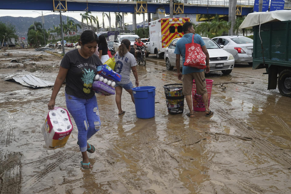 People loot a grocery store after Hurricane Otis ripped through Acapulco, Mexico, Wednesday, Oct. 25, 2023. Hurricane Otis ripped through Mexico's southern Pacific coast as a powerful Category 5 storm, unleashing massive flooding, ravaging roads and leaving large swaths of the southwestern state of Guerrero without power or cellphone service. (AP Photo/Marco Ugarte)