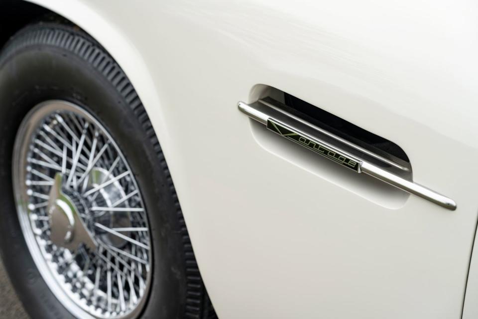 <p>The DB6 demonstrator has a charging port hidden under what would normally be its fuel filler, and we're told that there is also a small display screen in the cabin to report on different drivetrain modes, but in every other regard it seems to be unchanged, still having a rev counter and even exhaust tailpipes.</p>