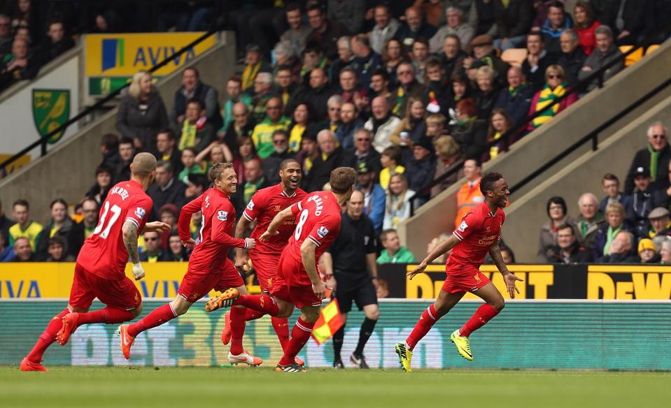 Liverpool's Raheem Sterling, right, celebrates scoring the opening goal during their English Premier League match against Norwich City at Carrow Road, Norwich, eastern England, Sunday April 20, 2014. (AP Photo/PA, Chris Radburn) UNITED KINGDOM OUT NO SALES NO ARCHIVE