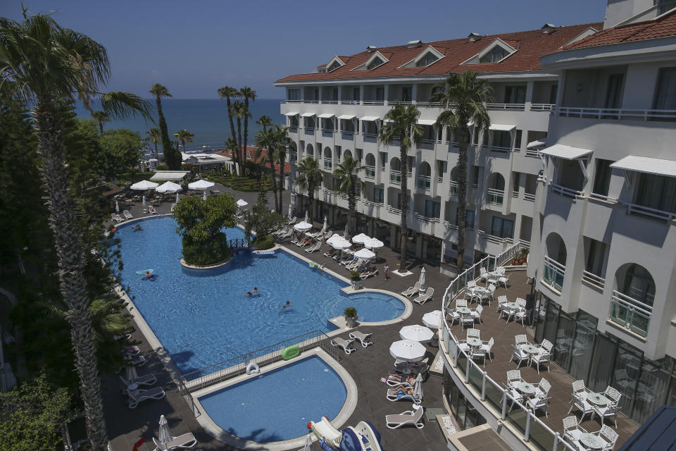 Tourists use a swimming pool in a hotel in Antalya, southern Turkey, Saturday, June 19, 2021. Hotels in Turkey's Antalya region, a destination beloved by holidaymakers, are preparing to finally resume operations as they expect the return of international tourists after months of setbacks caused by the pandemic that halted travel. (AP Photo/Emrah Gurel)