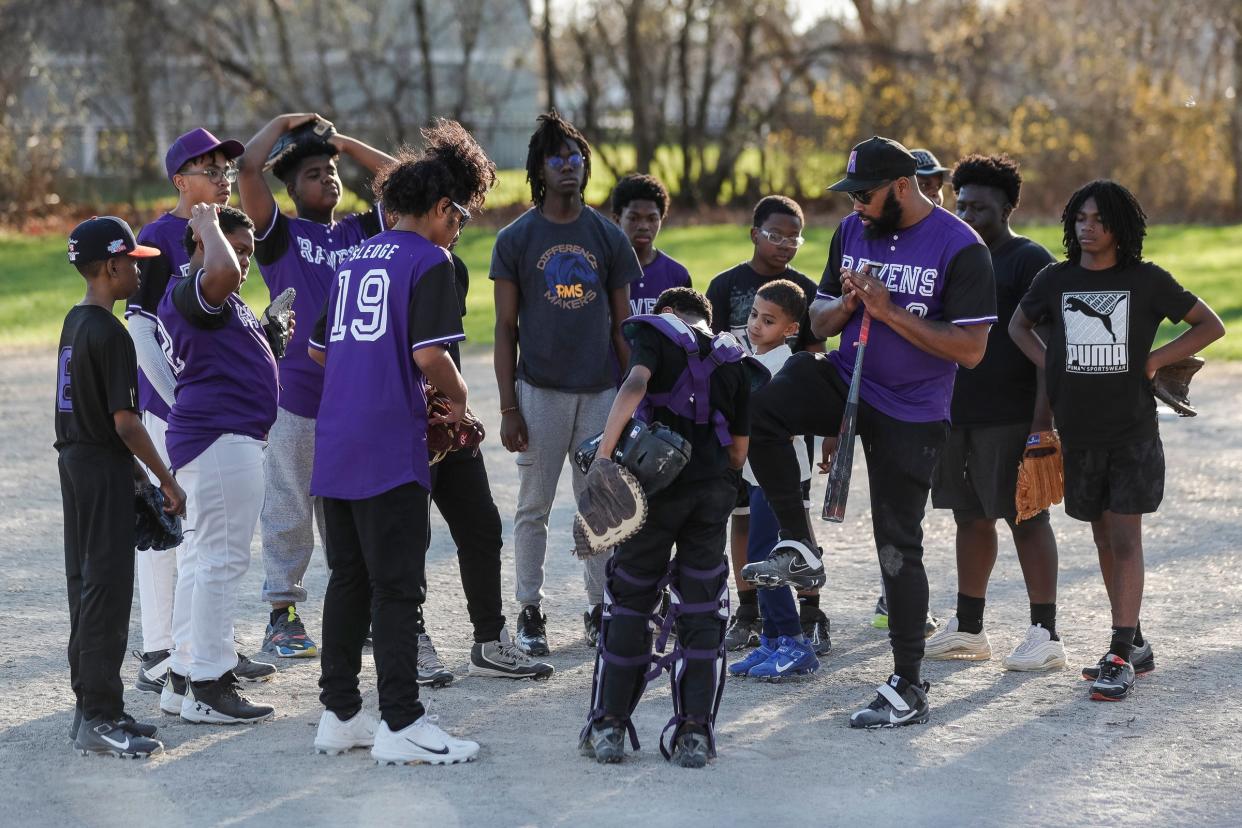Vincent McMullen, also called Coach Mac, center right, talks to players of the Motor City Ravens youth baseball team before practice at Calcara Park in Detroit on Wednesday, April 13, 2023.