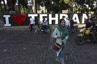 In this Saturday, May 18, 2019 photo, pedestrians and drivers make their way through a street in downtown Tehran, Iran. (AP Photo/Vahid Salemi)