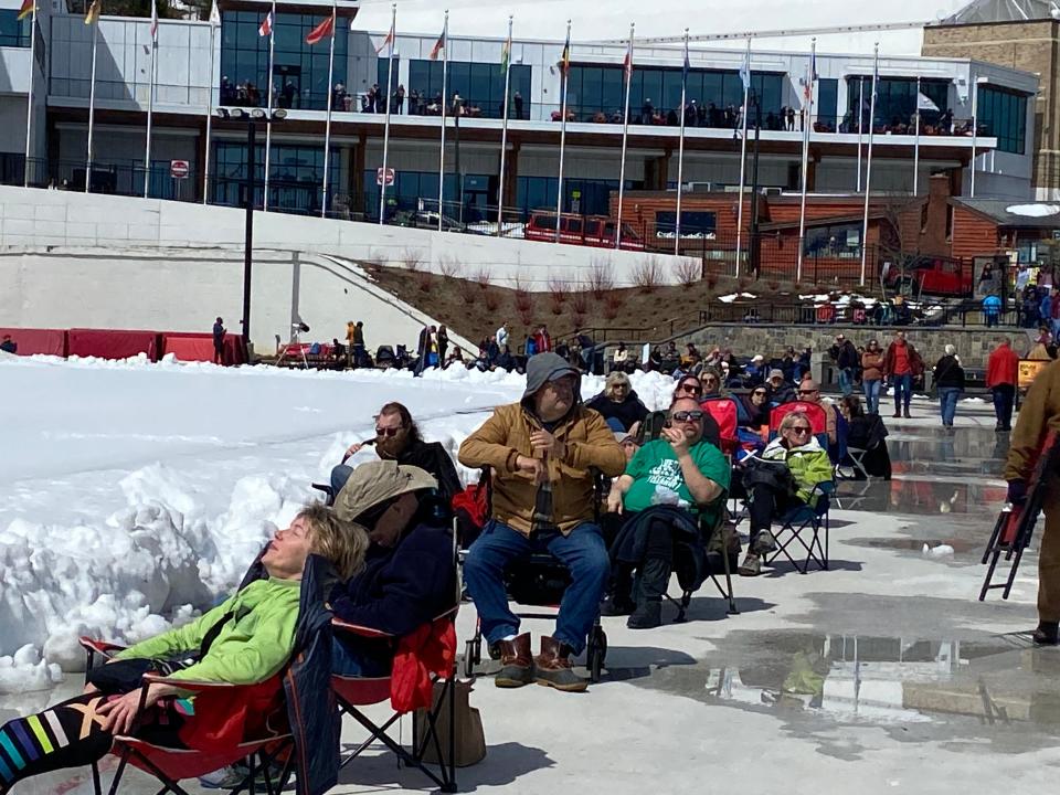 People wait for the eclipse outside the Olympic Skating Center in Lake Placid, NY, on Monday, April 8, 2024.