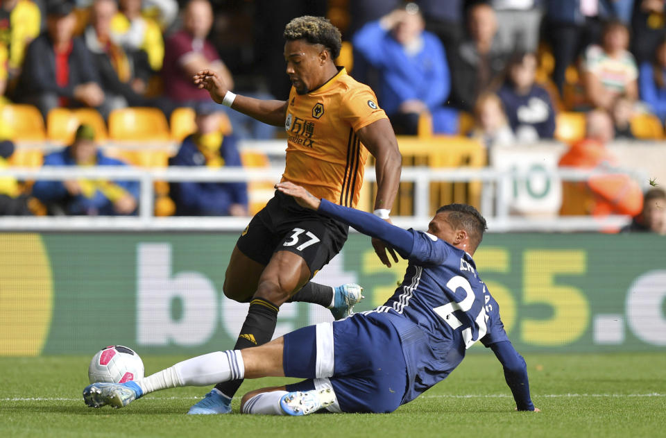 Wolverhampton Wanderers' Adama Traore, top, and Watford's Jose Holebas, in action during their English Premier League soccer match at Molineux Stadium in Wolverhampton, England, Saturday Sept. 28, 2019. (Dave Howarth/PA via AP)